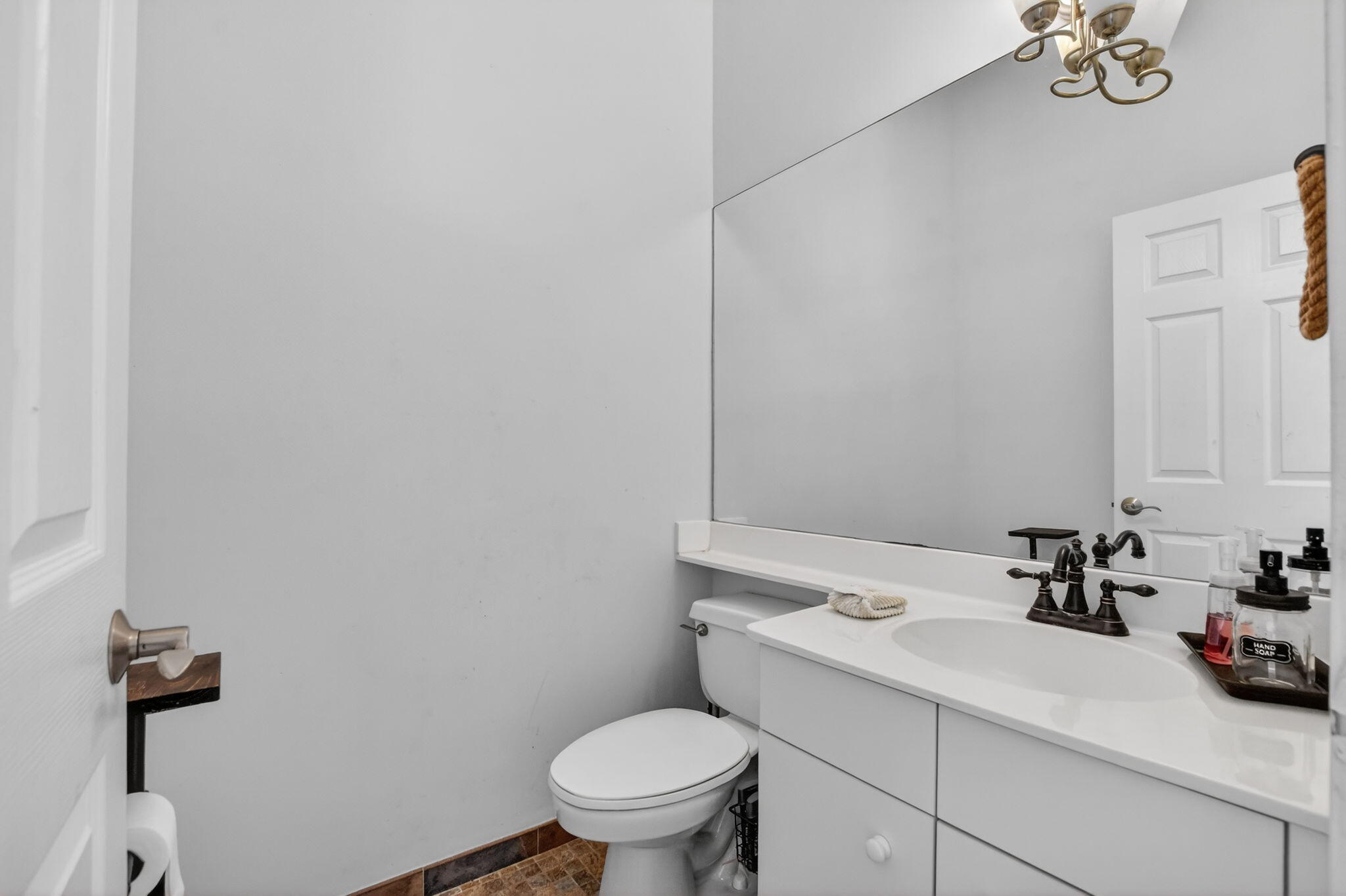 10058 Umberland Place Boca Raton, FL 33428 - Photo 27 of 55 a bathroom with a sink a toilet and mirror