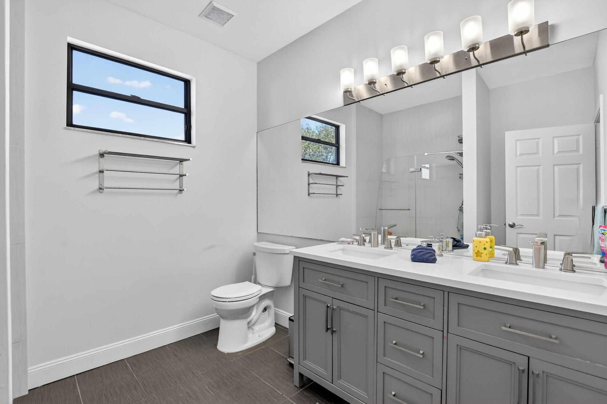 10058 Umberland Place Boca Raton, FL 33428 - Photo 31 of 55 a bathroom with a toilet sink and mirror