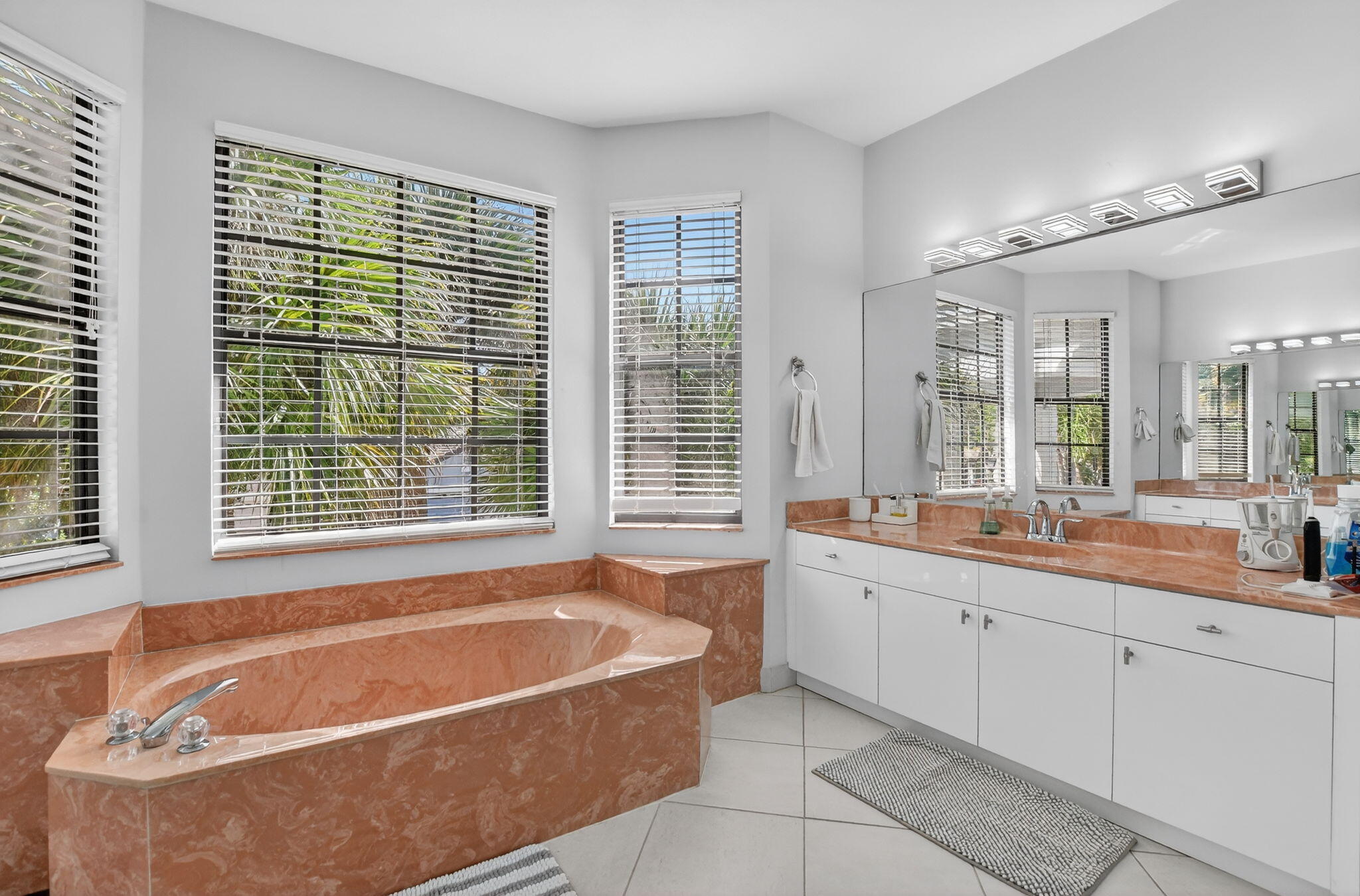 10058 Umberland Place Boca Raton, FL 33428 - Photo 38 of 55 a spacious bathroom with a tub a sink and a window