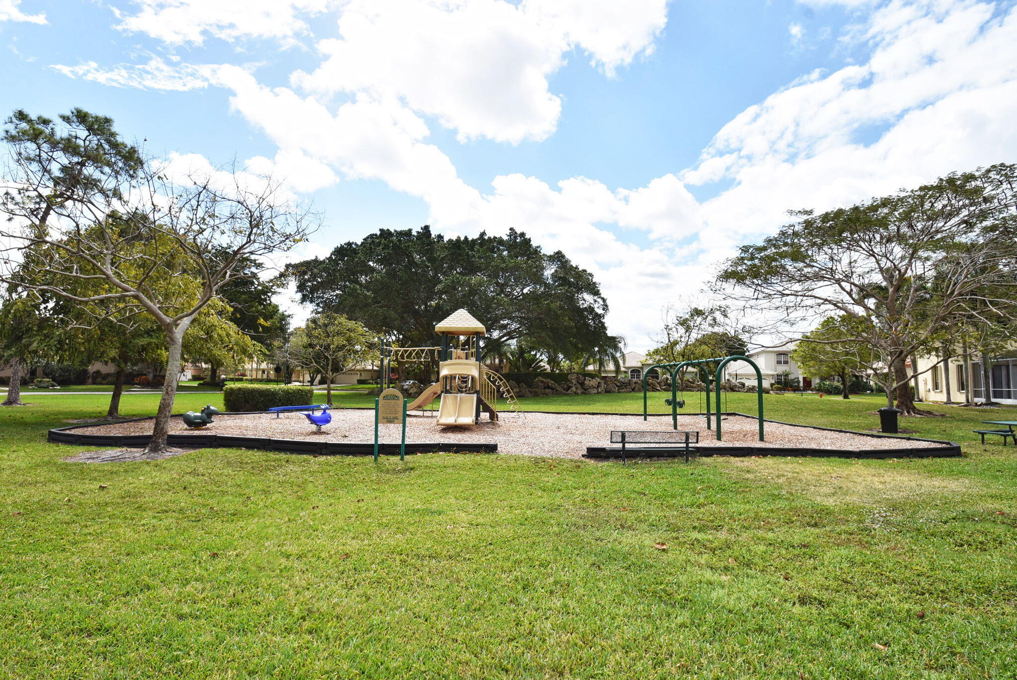 10058 Umberland Place Boca Raton, FL 33428 - Photo 52 of 55 a view of a park with swings and slides