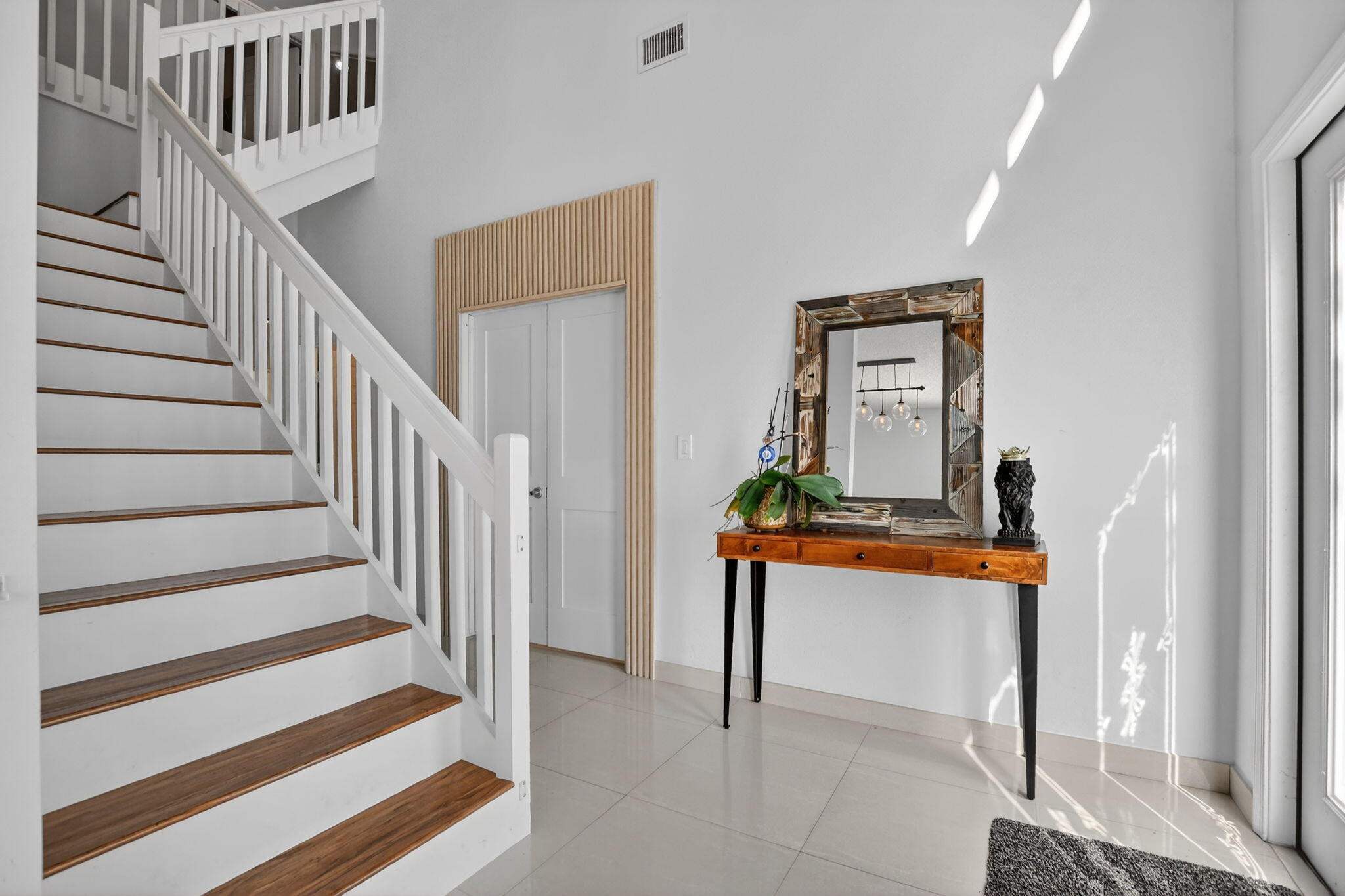 10058 Umberland Place Boca Raton, FL 33428 - Photo 6 of 55 a view of entryway and hall with wooden floor