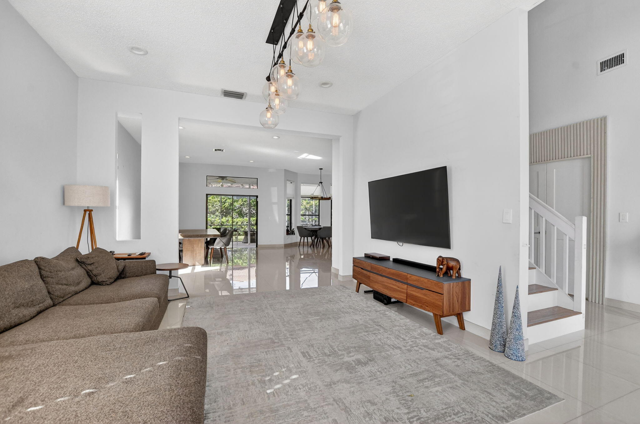 10058 Umberland Place Boca Raton, FL 33428 - Photo 9 of 55 a living room with furniture and a flat screen tv