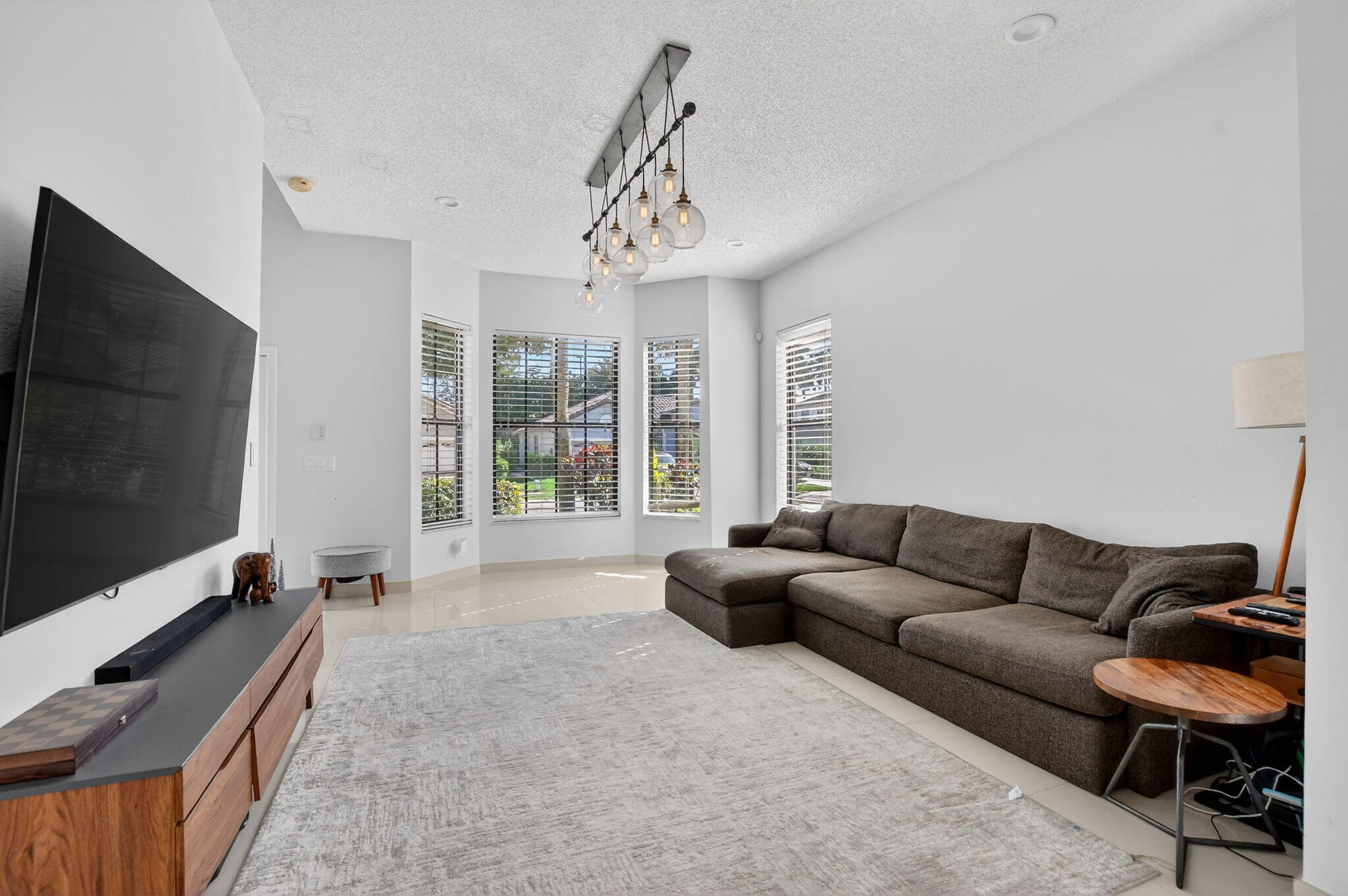 10058 Umberland Place Boca Raton, FL 33428 - Photo 10 of 55 a living room with furniture and a flat screen tv