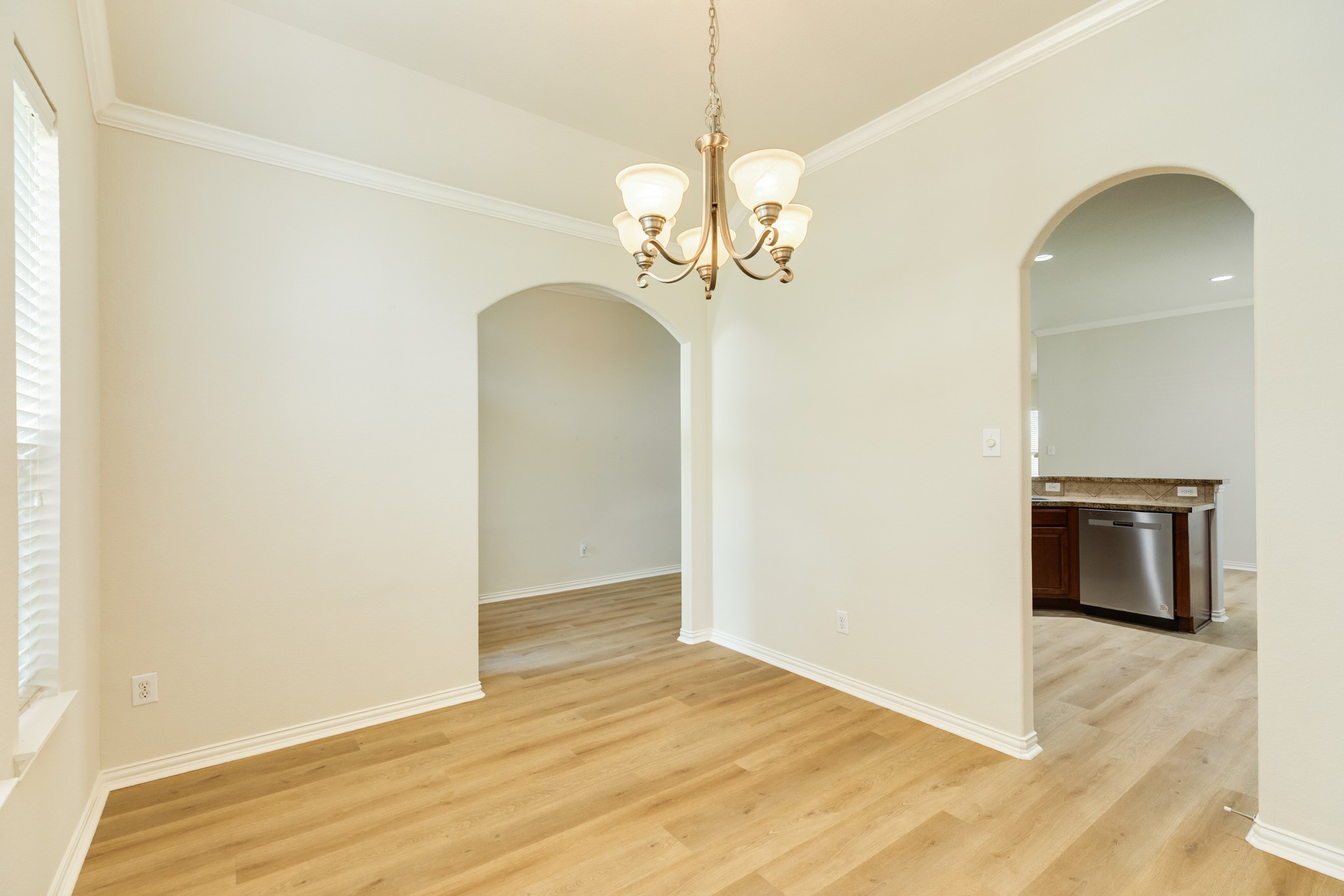 13417 Star Creek Lane Rosharon, TX 77583 - Photo 7 of 41 This view showcases the seamless transition between the formal dining area and the kitchen.