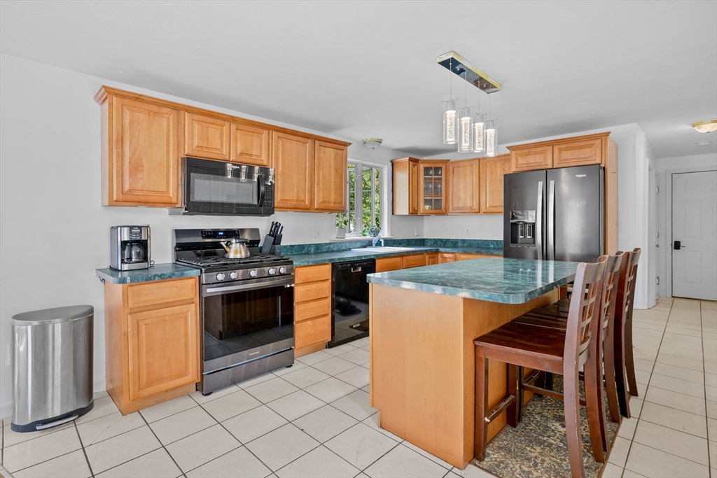16 Balfour Lane Mashpee, MA 02649 - Photo 11 of 32 a kitchen with stainless steel appliances granite countertop a stove top oven a sink dishwasher and a refrigerator