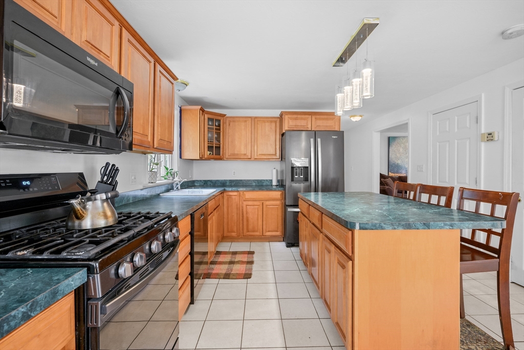 16 Balfour Lane Mashpee, MA 02649 - Photo 12 of 32 a kitchen with granite countertop a stove and a sink