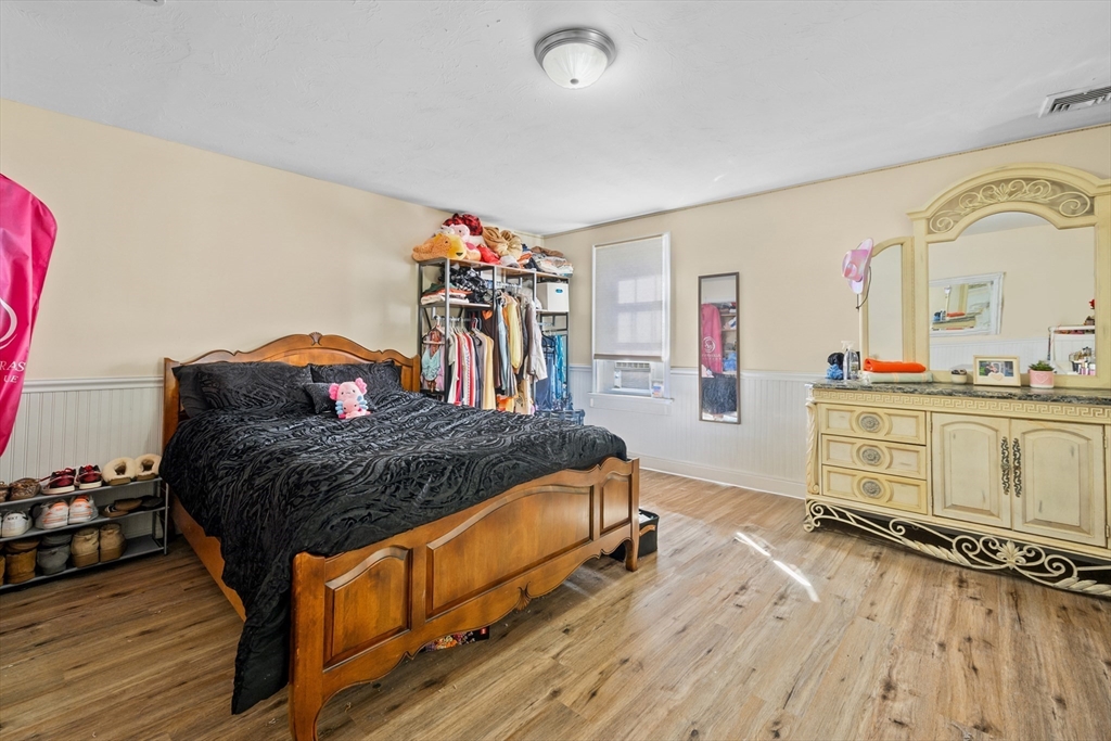16 Balfour Lane Mashpee, MA 02649 - Photo 20 of 32 a bedroom with a bed and wooden floor