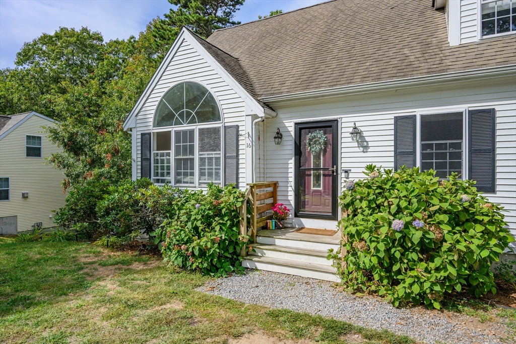 16 Balfour Lane Mashpee, MA 02649 - Photo 4 of 32 a front view of a house with a yard