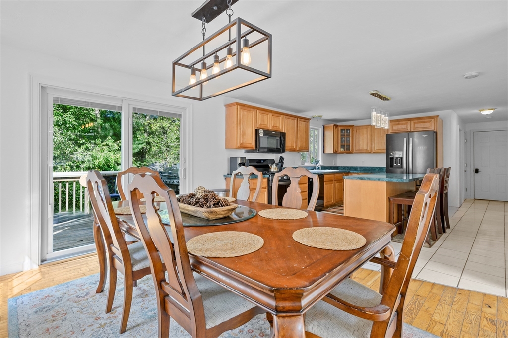 16 Balfour Lane Mashpee, MA 02649 - Photo 8 of 32 a view of a dining room with furniture a kitchen and chandelier
