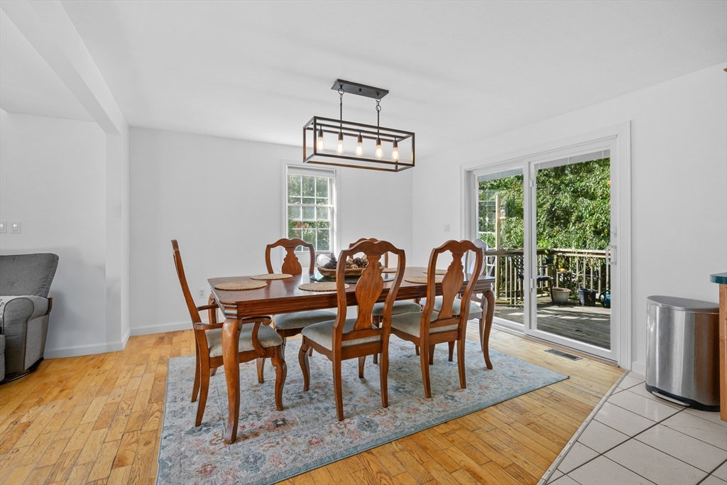16 Balfour Lane Mashpee, MA 02649 - Photo 9 of 32 a view of a dining room with furniture a chandelier and wooden floor