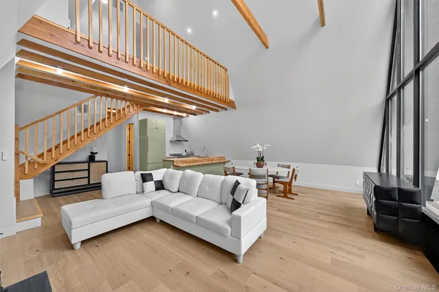 a living room with furniture and stairs