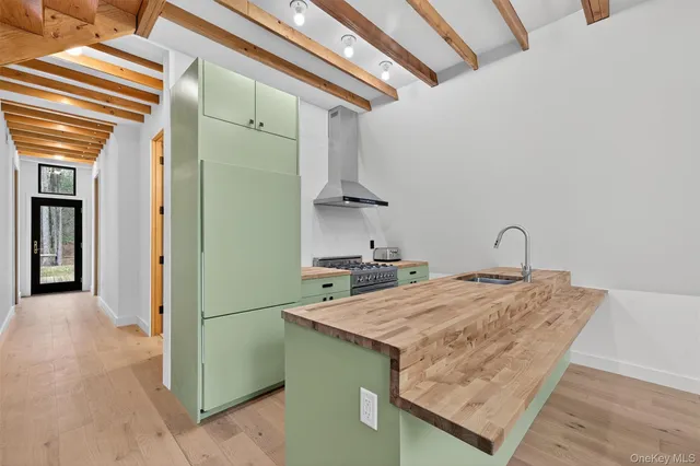 a kitchen with a sink a refrigerator and cabinets
