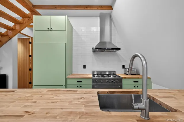 a kitchen with stainless steel appliances granite countertop a stove and a refrigerator