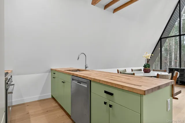 a room with a sink cabinets and a wooden floor