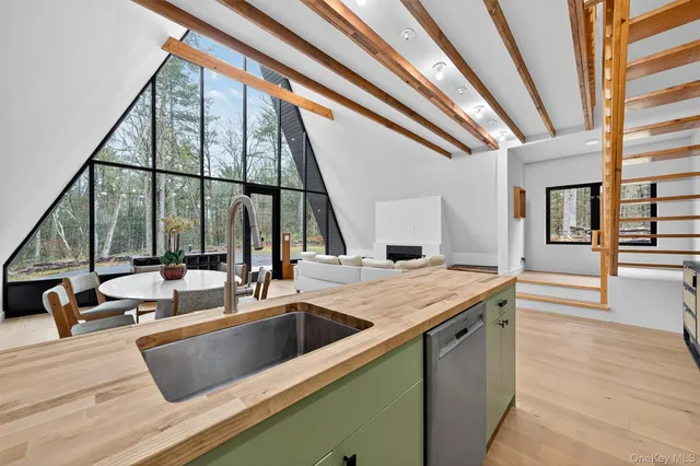 a kitchen that has a sink and a wooden floor