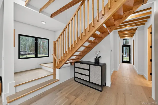 a view of entryway and hall with wooden floor