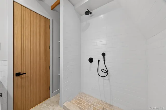 a bathroom with a glass shower door