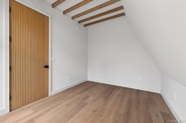 an empty room with wooden floor