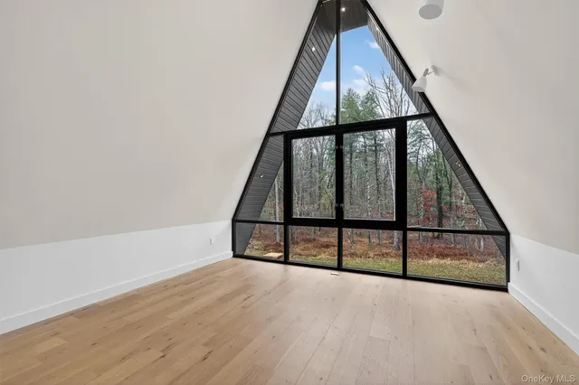 a view of staircase with wooden floor and white walls