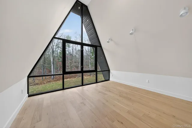 a view of staircase with wooden floor and white walls
