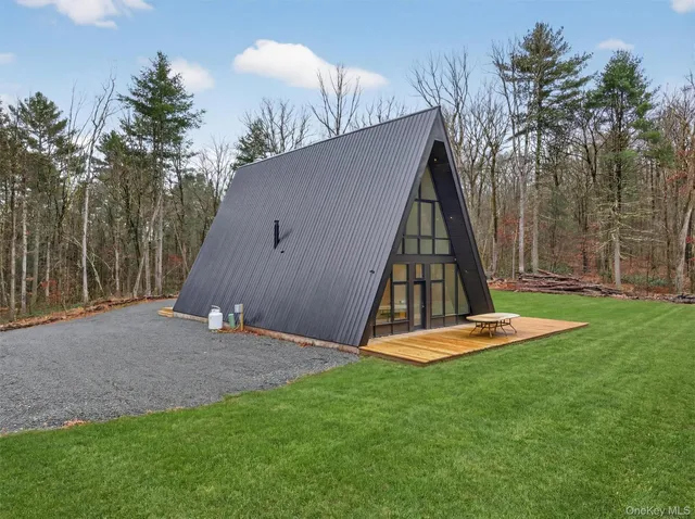 a view of backyard with a cabin and wooden fence