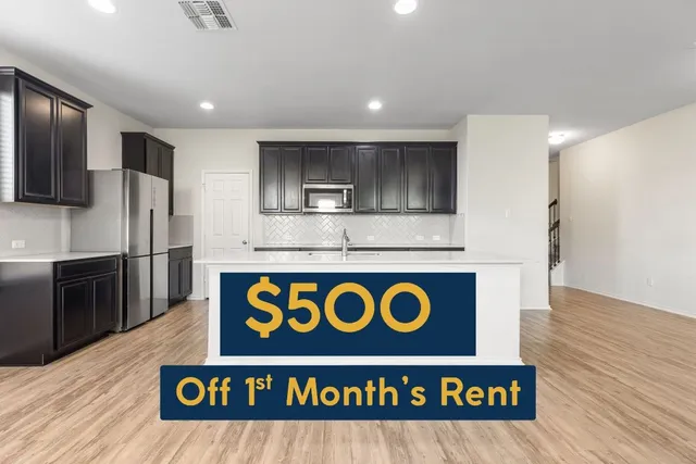 a kitchen with kitchen island stainless steel appliances a sink and a refrigerator