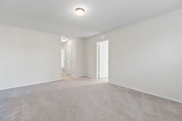a utility room with wooden floor washer and dryer