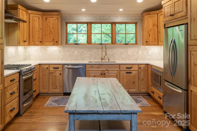 a kitchen with a sink stove and refrigerator