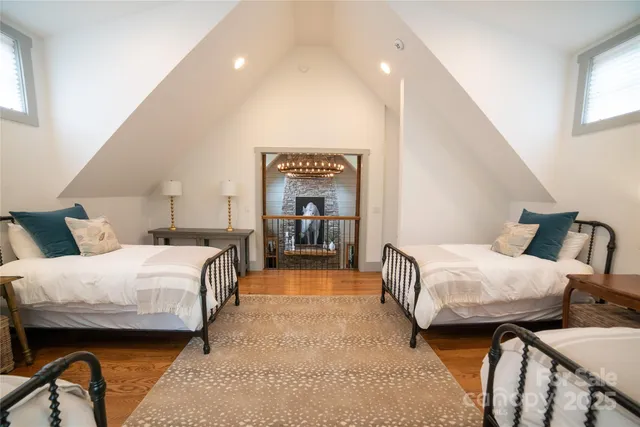 a bedroom with bed and a large mirror