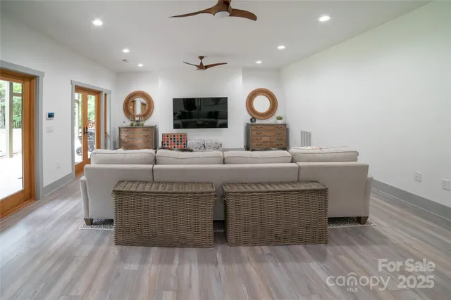 a living room with furniture and a wooden floor