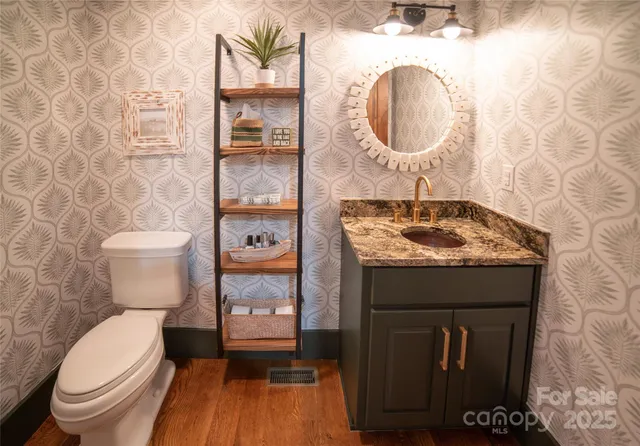 a bathroom with a toilet a sink and a mirror