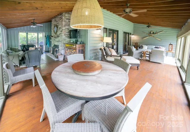a dining room with furniture and a wooden floor