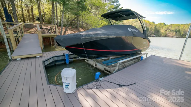 a view of a roof deck with table and chairs under an umbrella with wooden floor