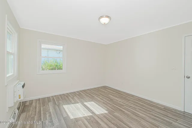a bedroom with bed and a potted plant