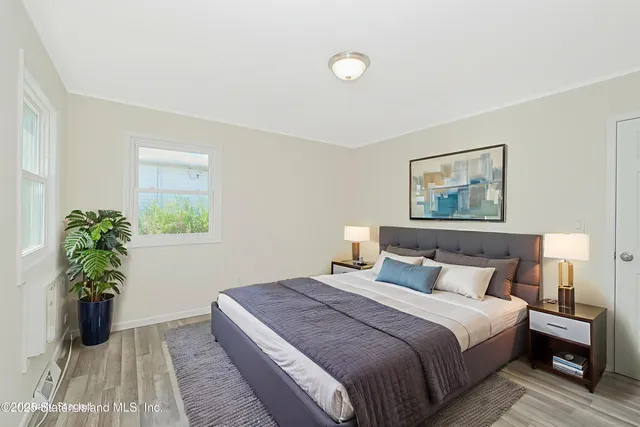 a view of a room with wooden floor and white walls