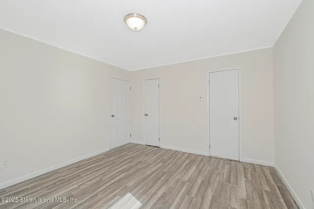 a view of a room with wooden floor and closet