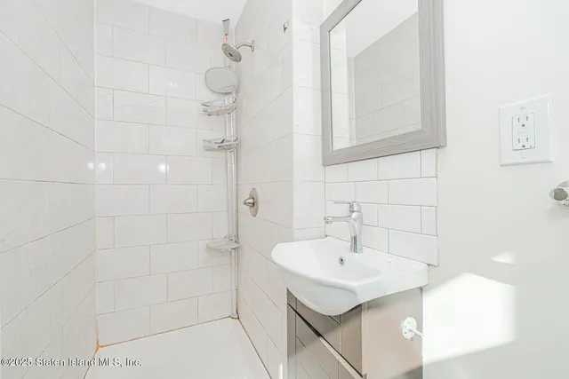 a view of small space with wooden floor and fan