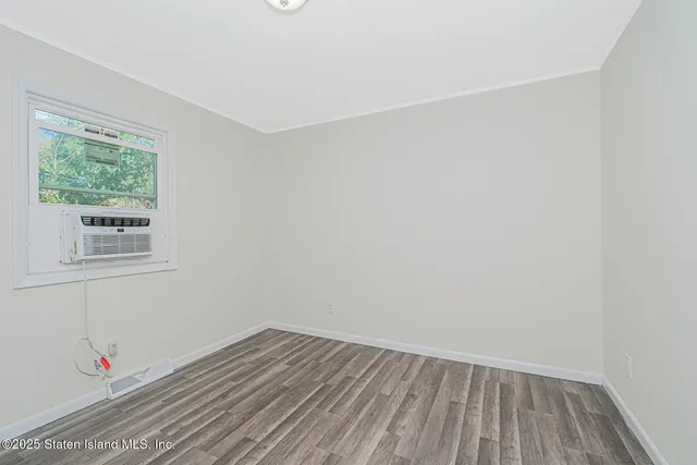 a view of a room with wooden floor and entryway