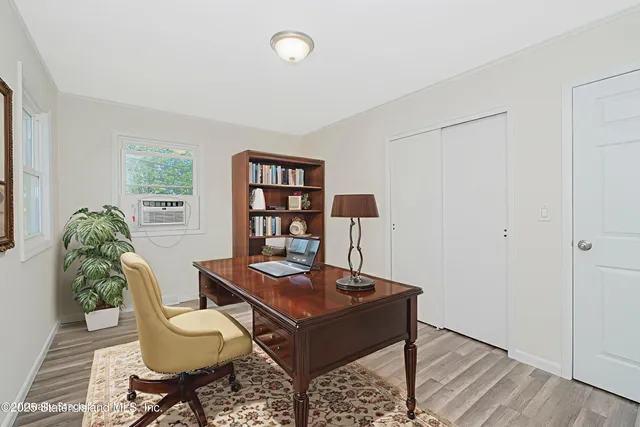 a view of an empty room with wooden floor