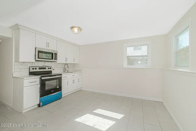 a kitchen with granite countertop a stove and a refrigerator