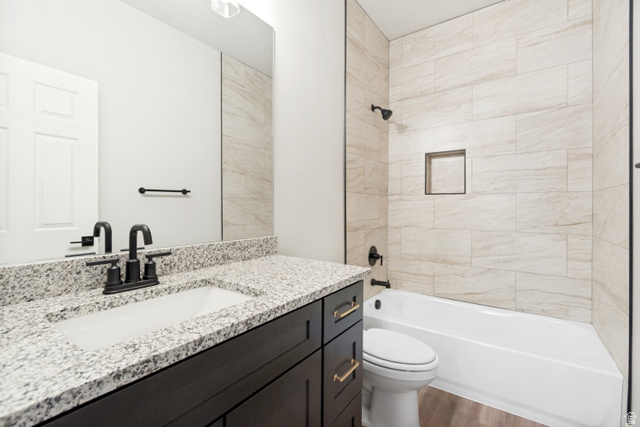 529 North Hvn Drive Mapleton, UT 84664 - Photo 22 of 30 Bathroom featuring a vanity with a white rectangular undermount sink, granite countertop, and dark wood-finish cabinetry with gold-tone hardware