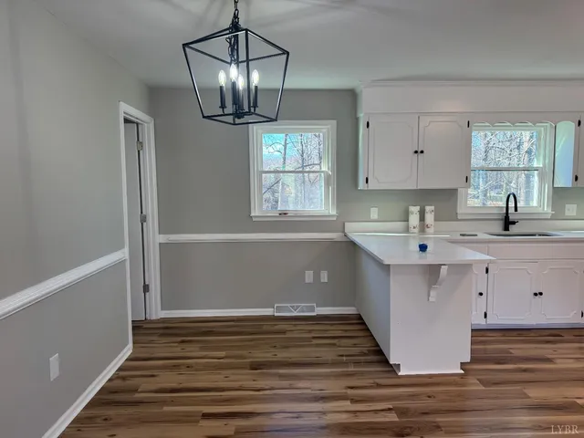 a kitchen with a sink cabinets and window