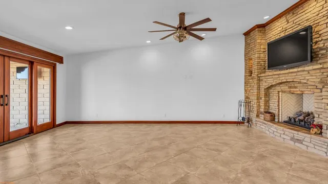 an empty room with furniture and a fireplace