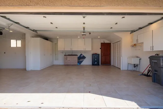 a view of a house with a yard and potted plants