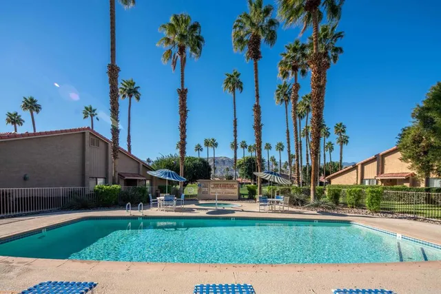 a view of a house with a swimming pool and a yard