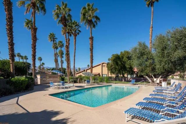 a aerial view of a house with a big yard and potted plants