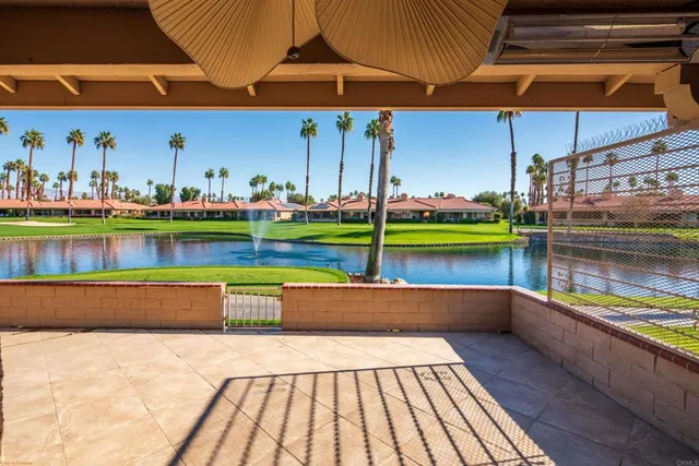 a backyard of a house with lots of green space and fountain