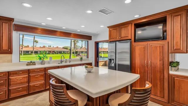 a kitchen with stainless steel appliances granite countertop a sink a microwave cabinets and wooden floor