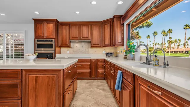 a view of a swimming pool with a lawn chairs and plants