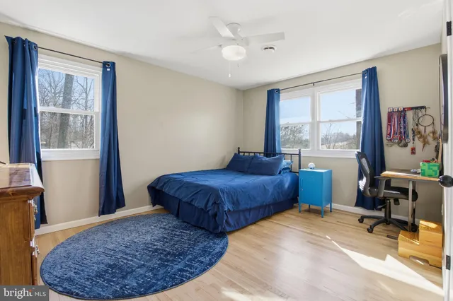 a bed room with a bed and a chair